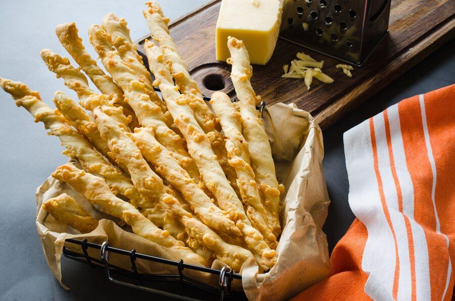 cheese-stick-breadsticks-with-cheese-dark-background-concept-snack-party-time_74580-1676.jpg